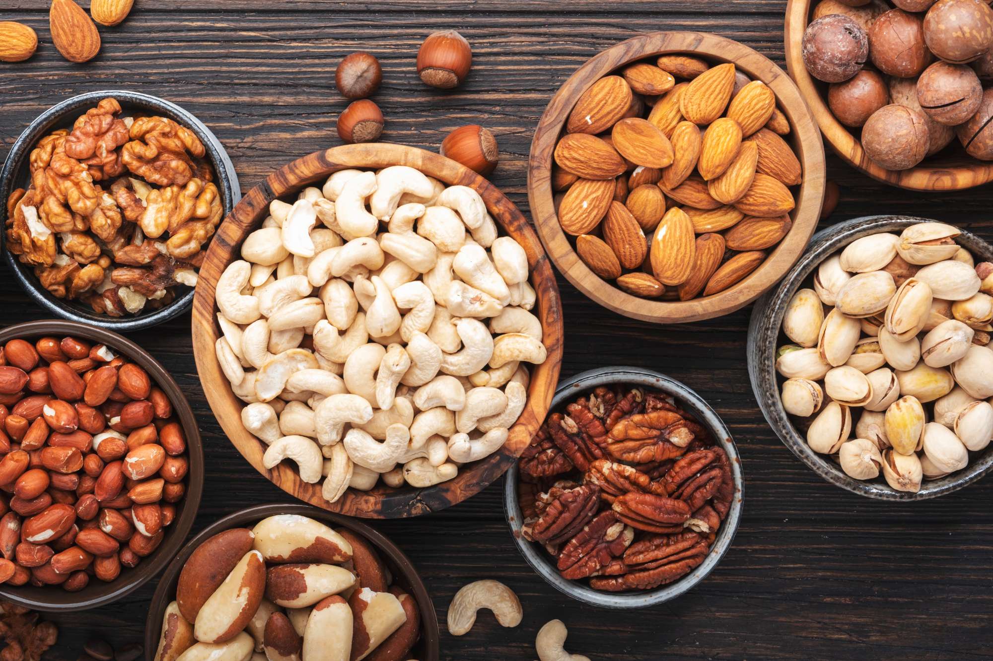 nuts-assortment-walnuts-pecans-almonds-other-healthy-food-snack-mix-wooden-table-background-top-view.jpg