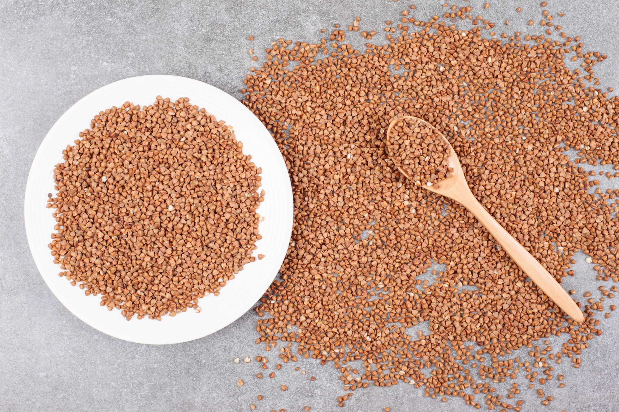 raw-buckwheat-white-plate-with-wooden-spoon.jpg