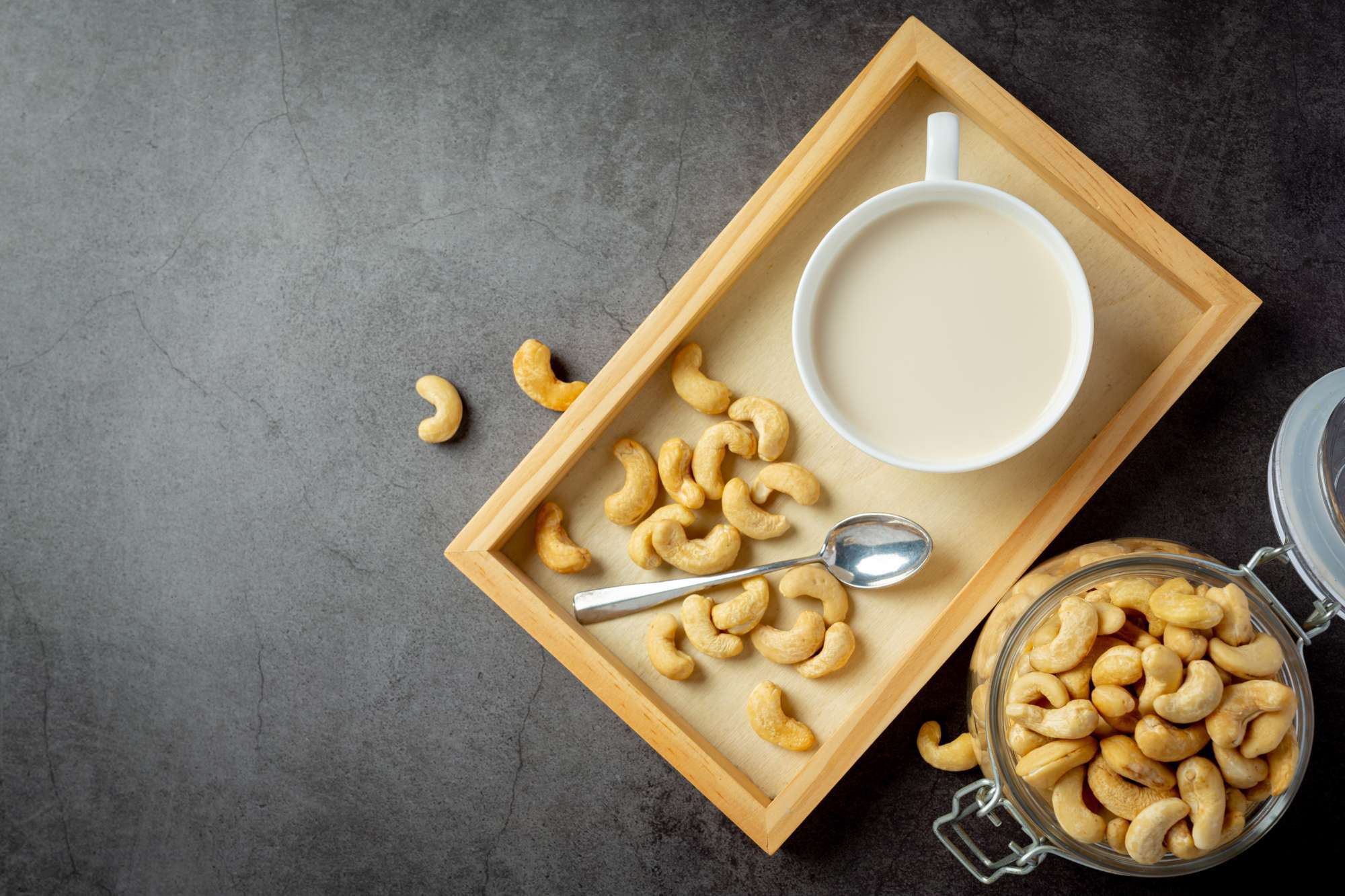 vegan-cashew-milk-glass-with-cashews-nuts-dark-background.jpg