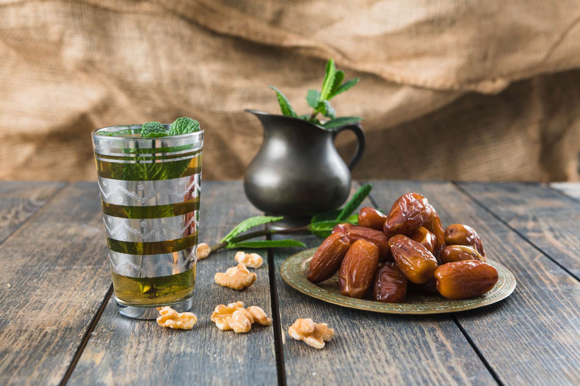 cup-drink-near-pitcher-nuts-plant-twigs-dried-fruits-table.jpg