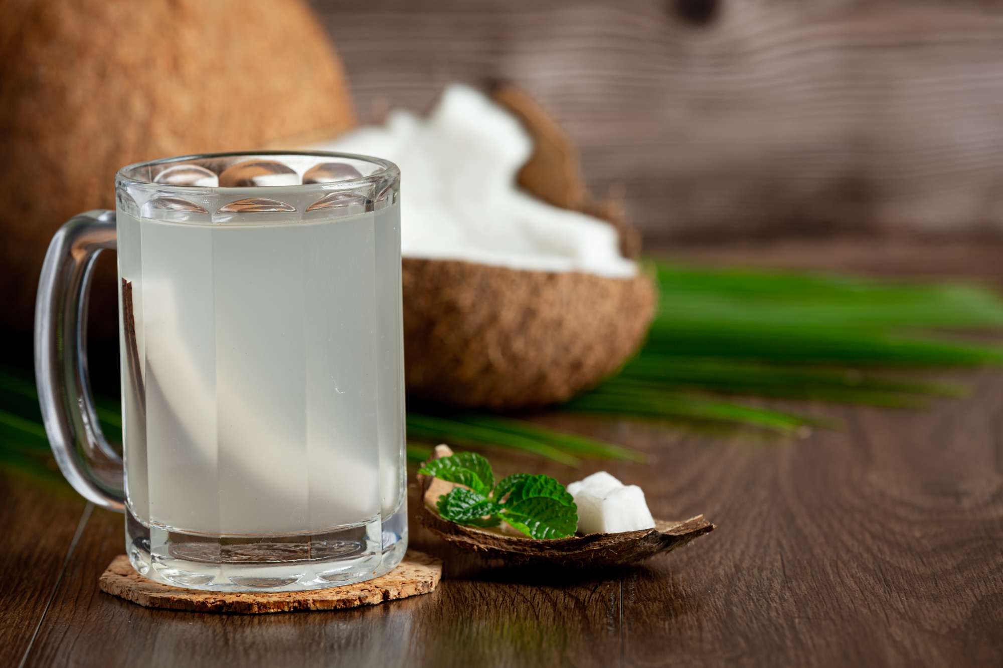 glass-coconut-water-put-dark-wooden-background.jpg