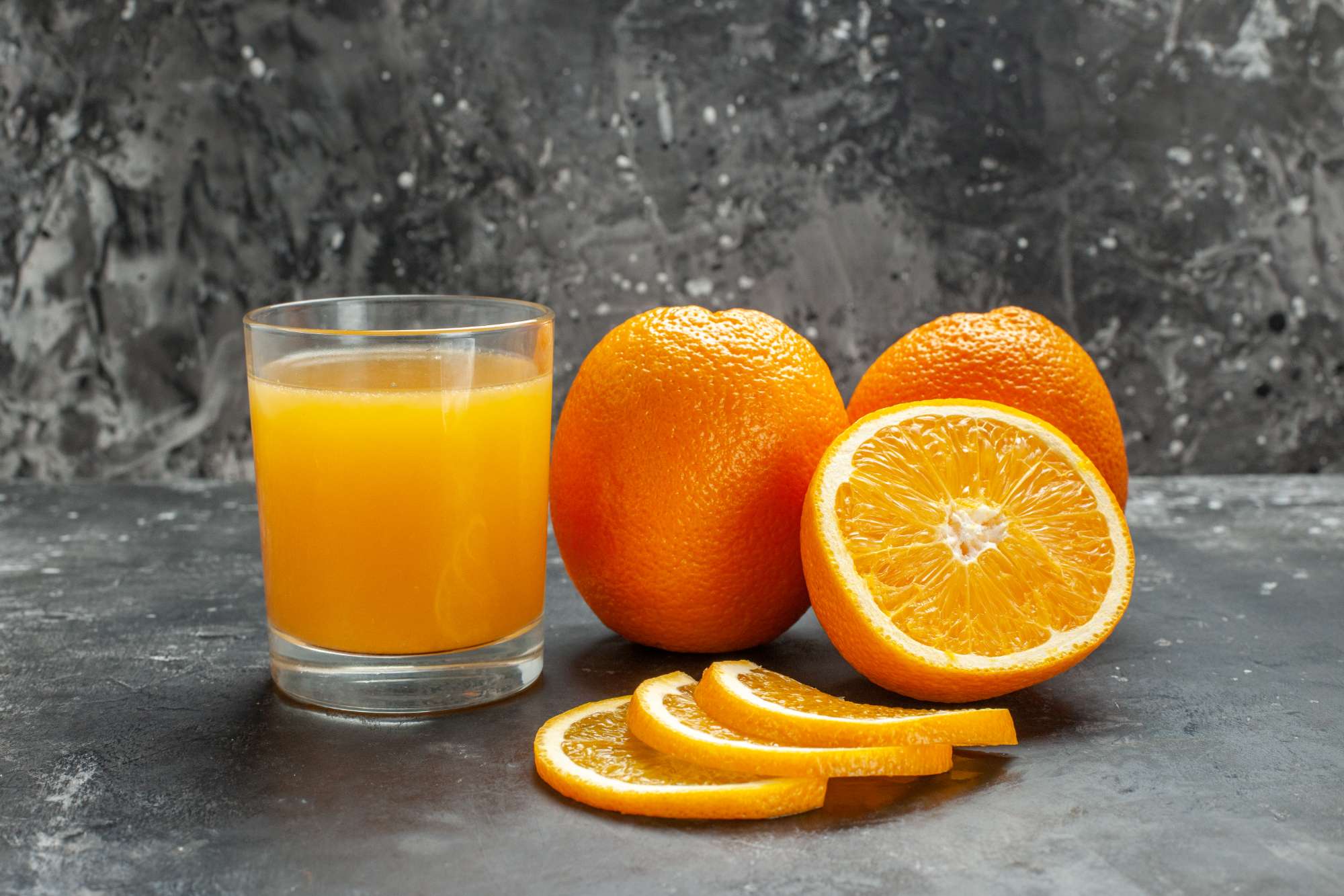 close-up-view-vitamin-source-cut-chopped-whole-fresh-oranges-gray-background.jpg