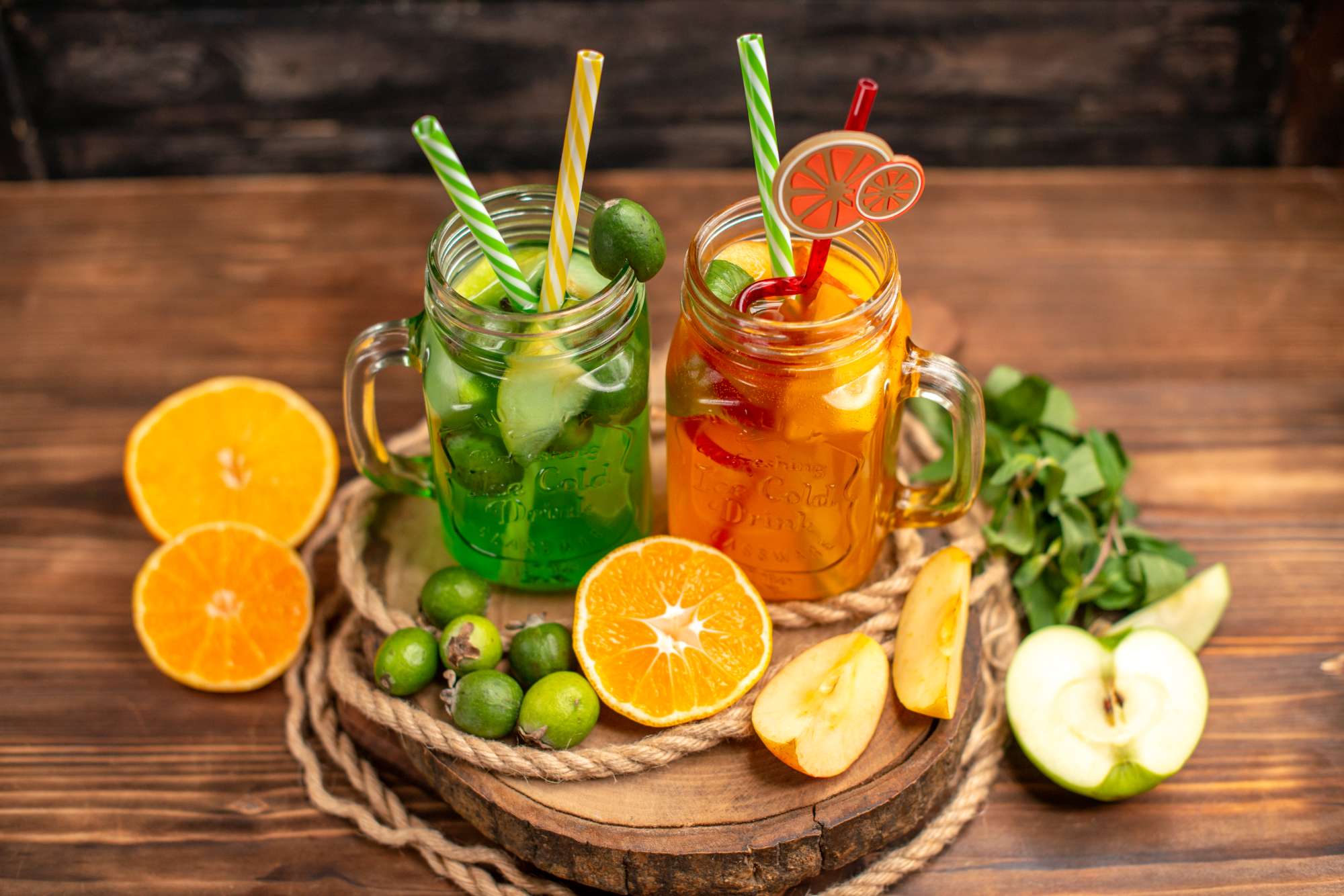 top-view-delicious-fresh-juices-fruits-wooden-tray-brown-background.jpg