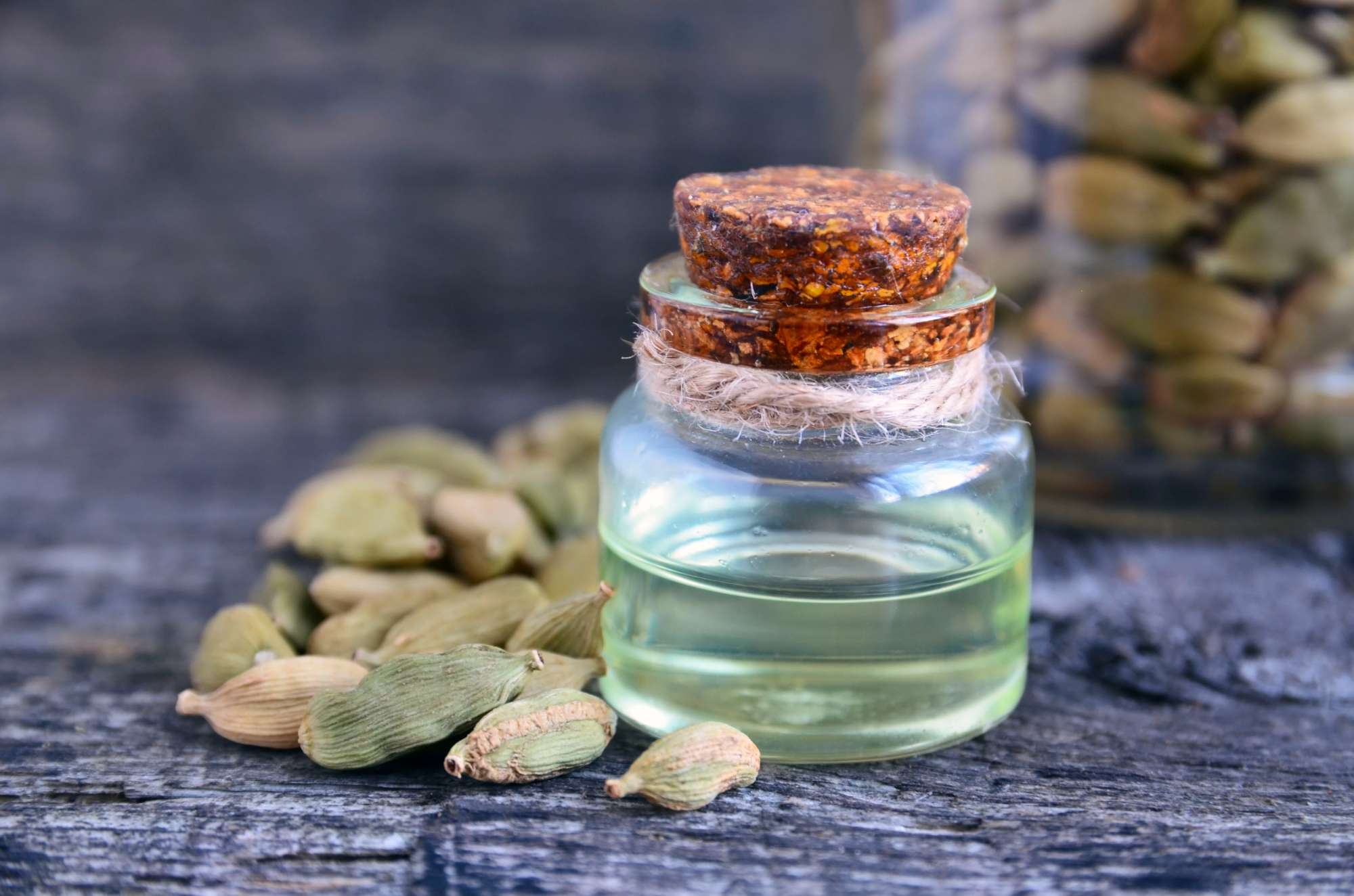 cardamom-essential-oil-glass-bottle-old-wooden-table-elettaria-cardamomum-extract.jpg