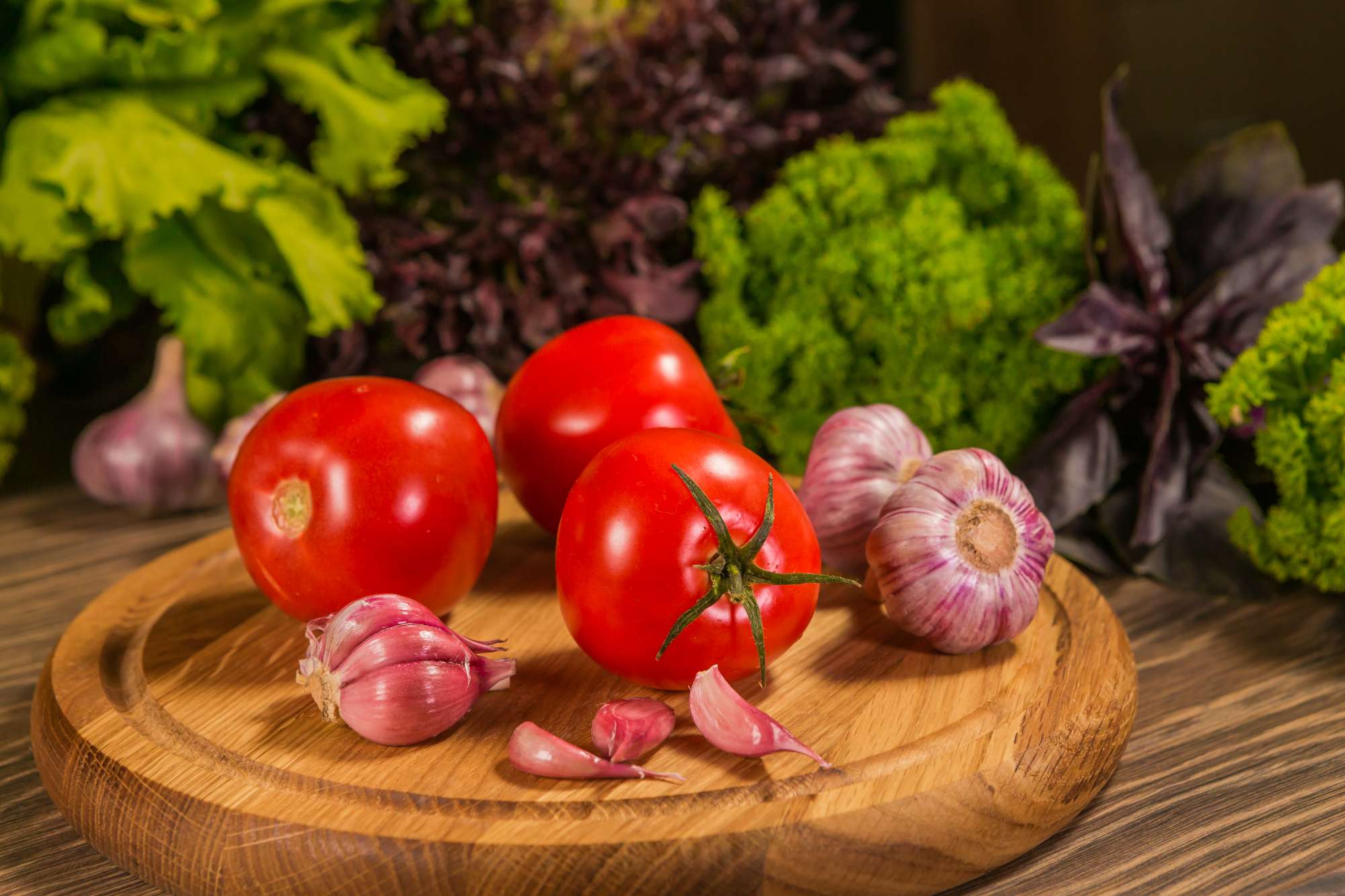 wooden-board-with-fresh-tomatoes-garlic-green-salad-background.jpg
