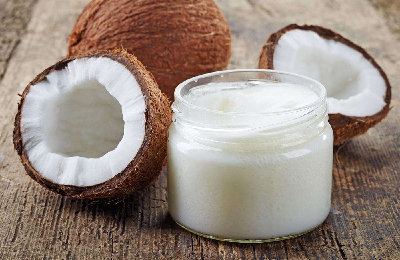 fresh-coconuts-and-a-jar-of-coconut-oil-on-a-wooden-royalty-free-image-466130802-1535553752.jpg