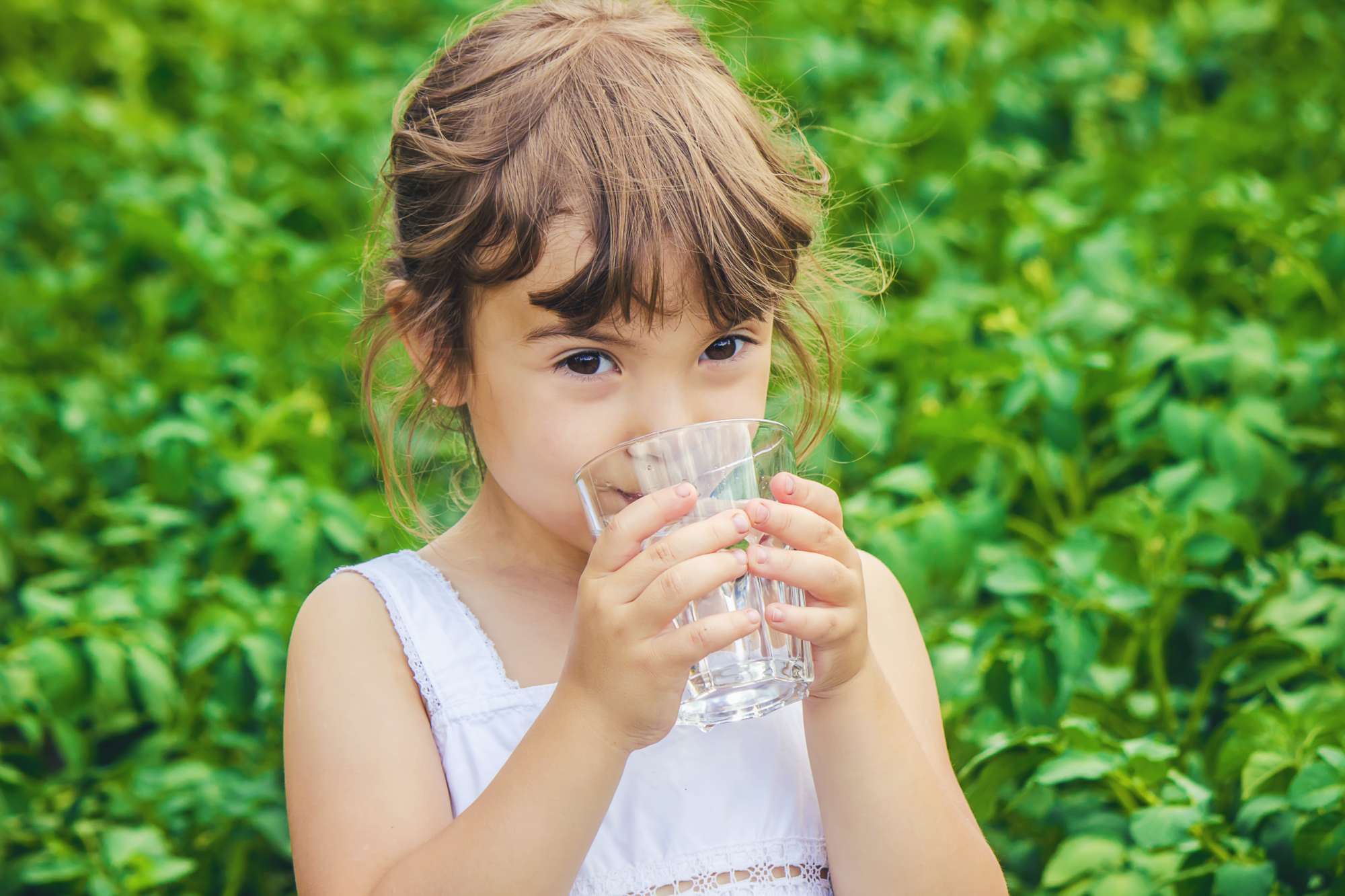 child-glass-water-selective-focus.jpg