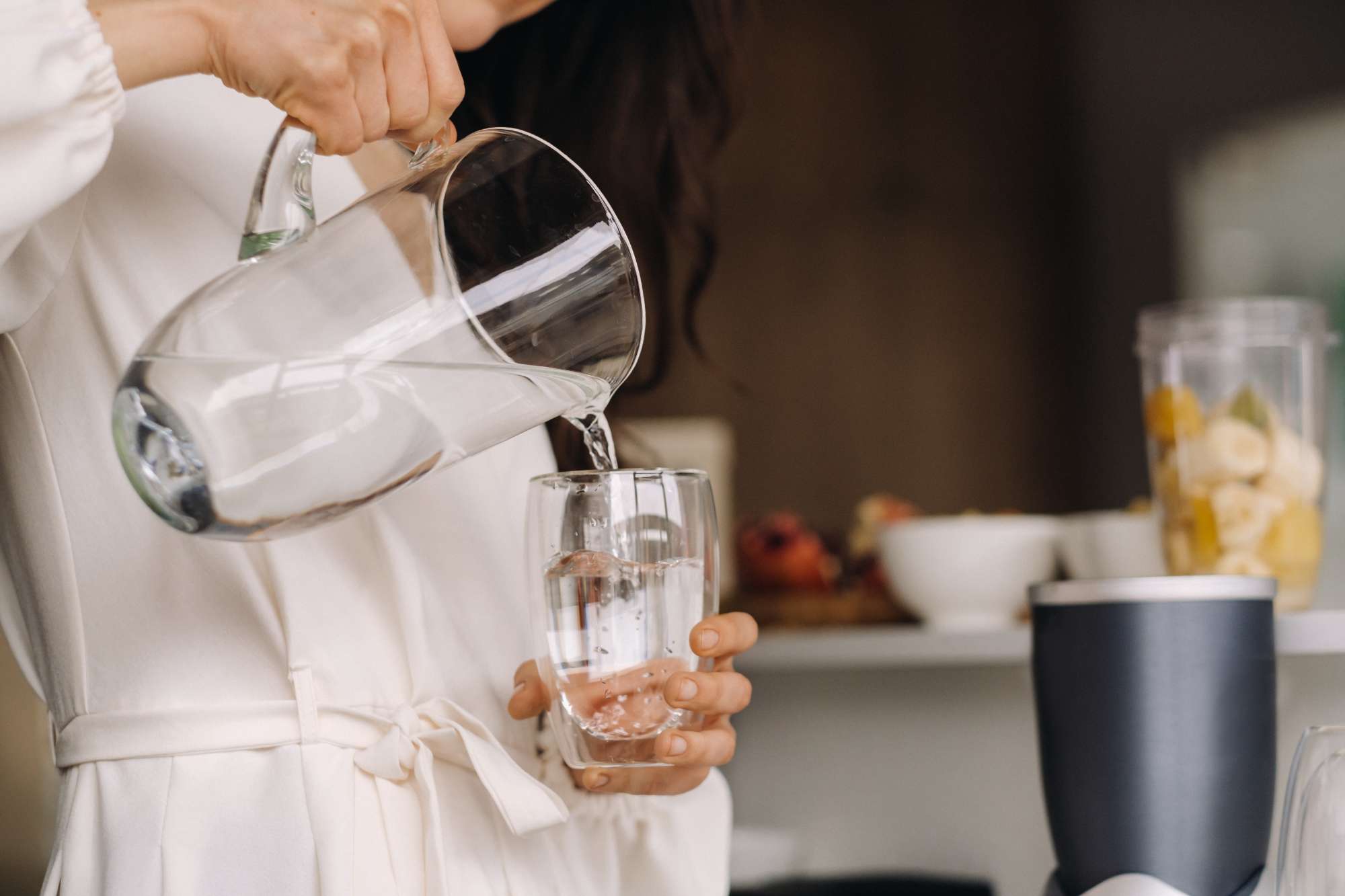 closeup-hands-girl-kitchen-who-pours-clean-water-into-glass-healthy-eating.jpg