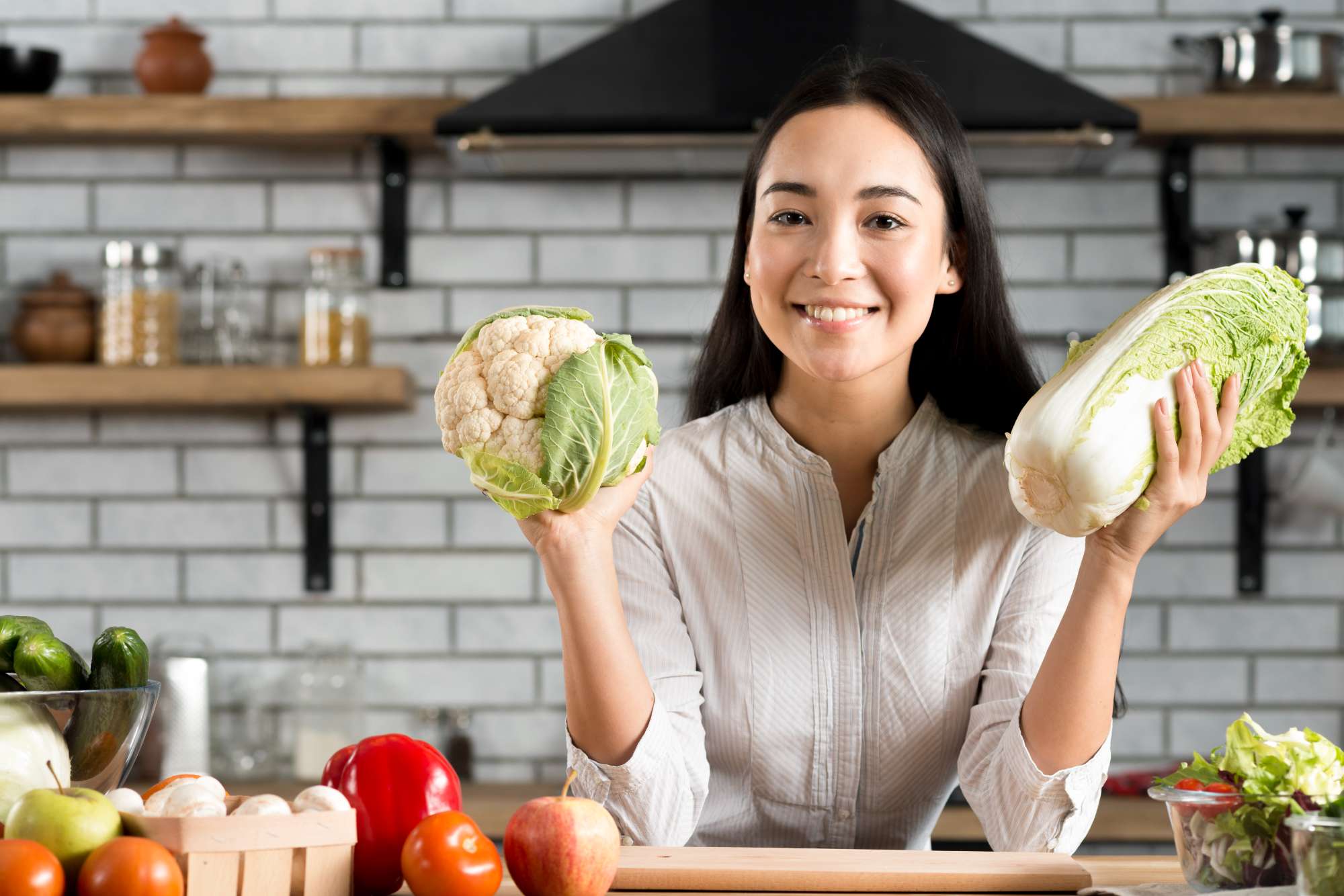 happy-young-woman-showing-fresh-vegetables-kitchen.jpg