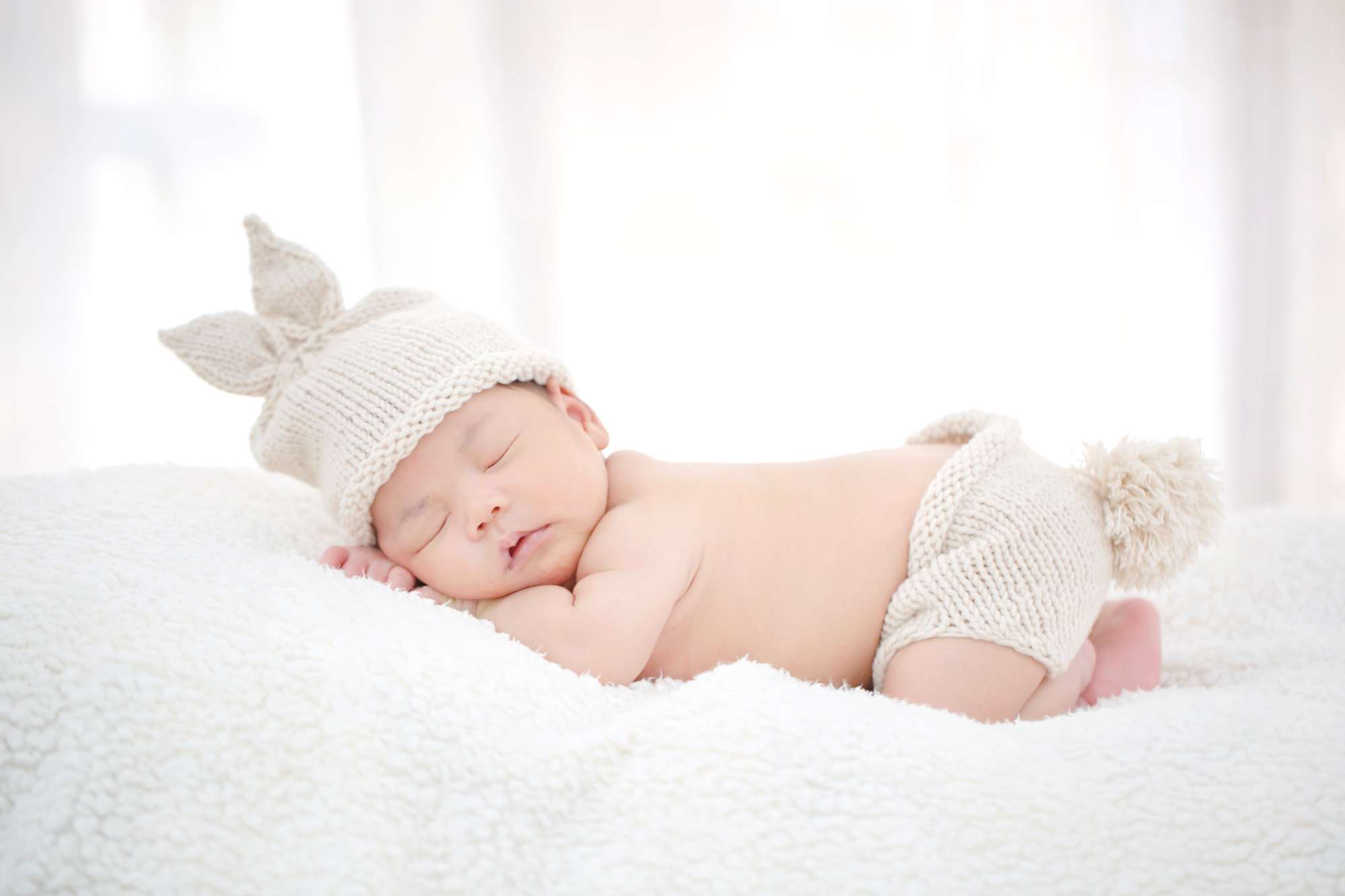 lovely-newborn-asian-baby-sleeping-furry-cloth.jpg