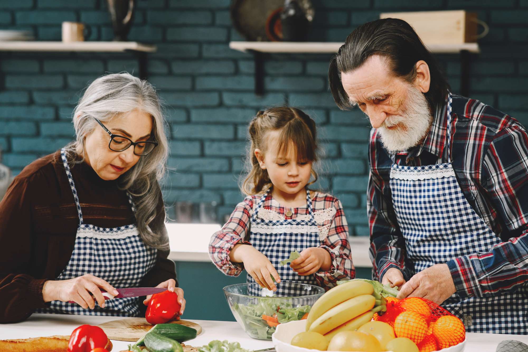 mature-couple-their-granddaughter-preparing-food.jpg