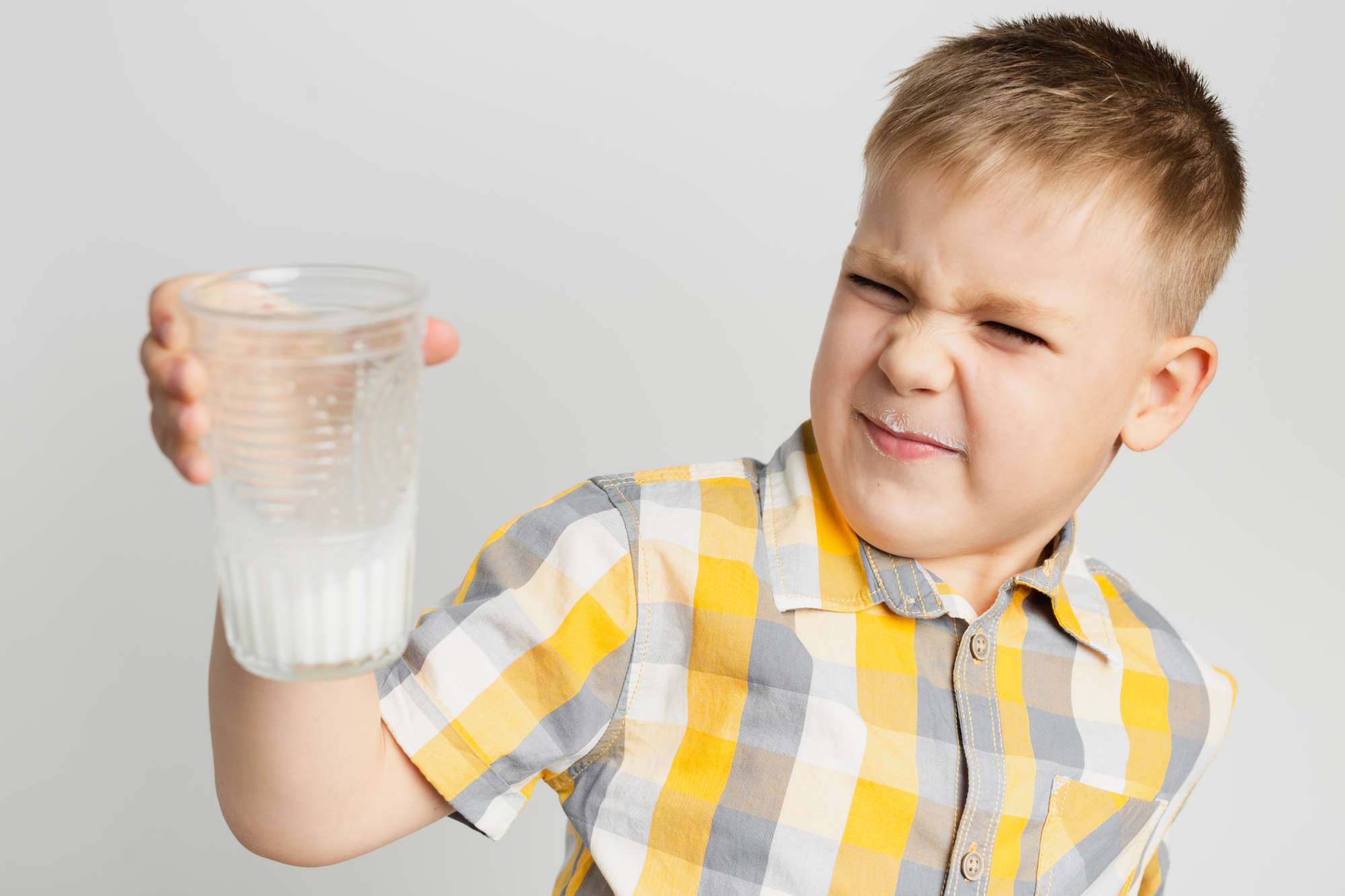 young-silly-boy-holding-glass-milk.jpg