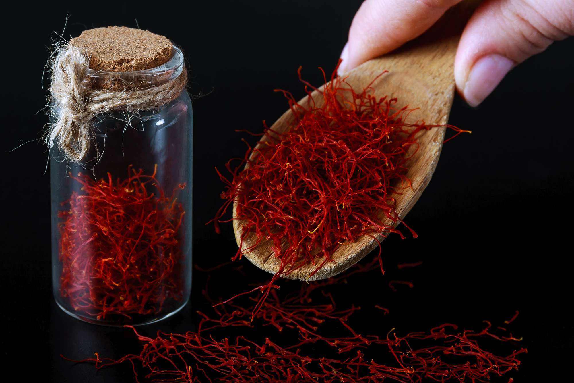 dry-spice-saffron-glass-bottle-wooden-spoon-black-background.jpg