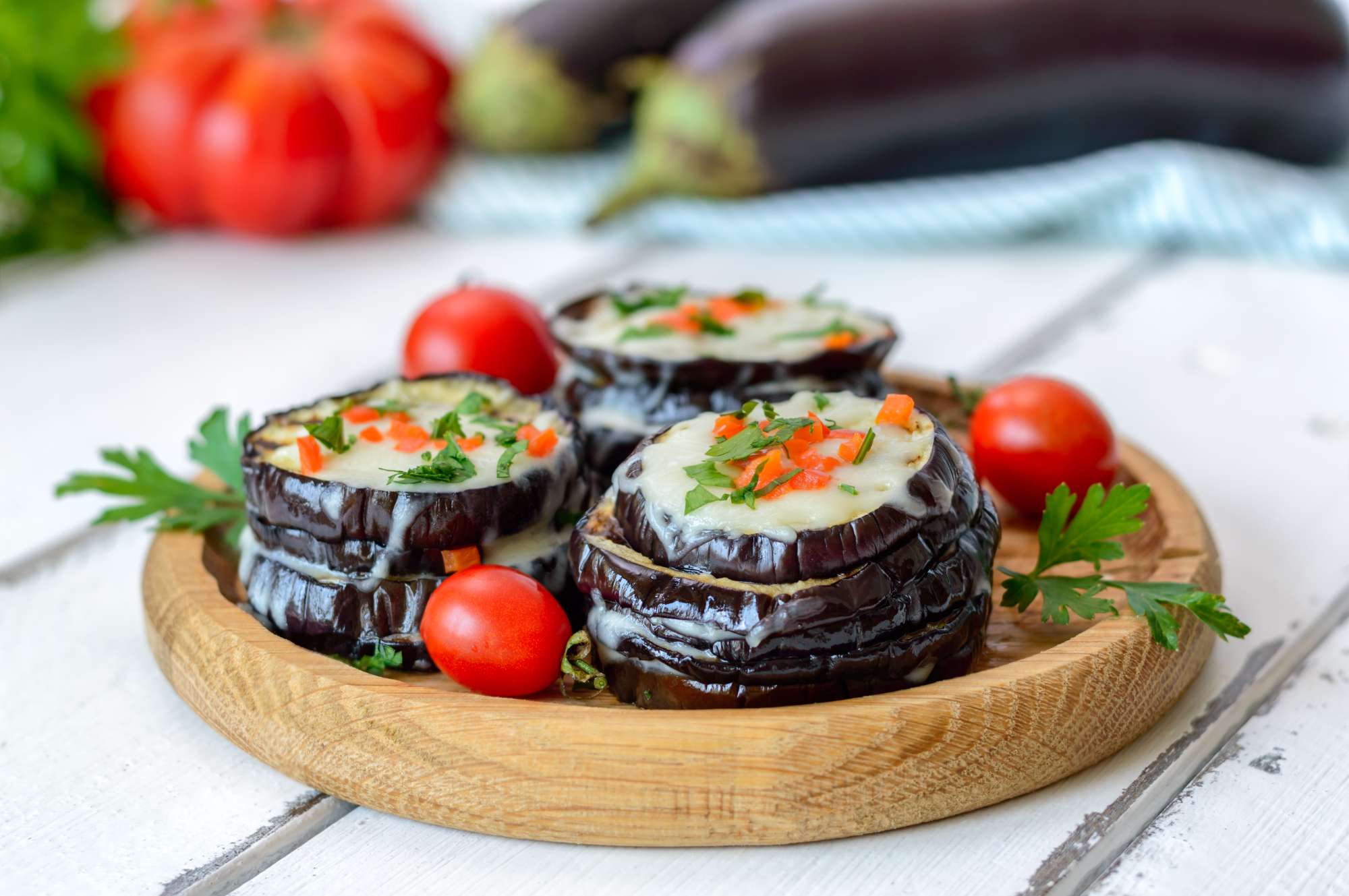 eggplant-baked-with-mozzarella-cheese-tomatoes-wooden-plate-vegetarian-food-recipe.jpg