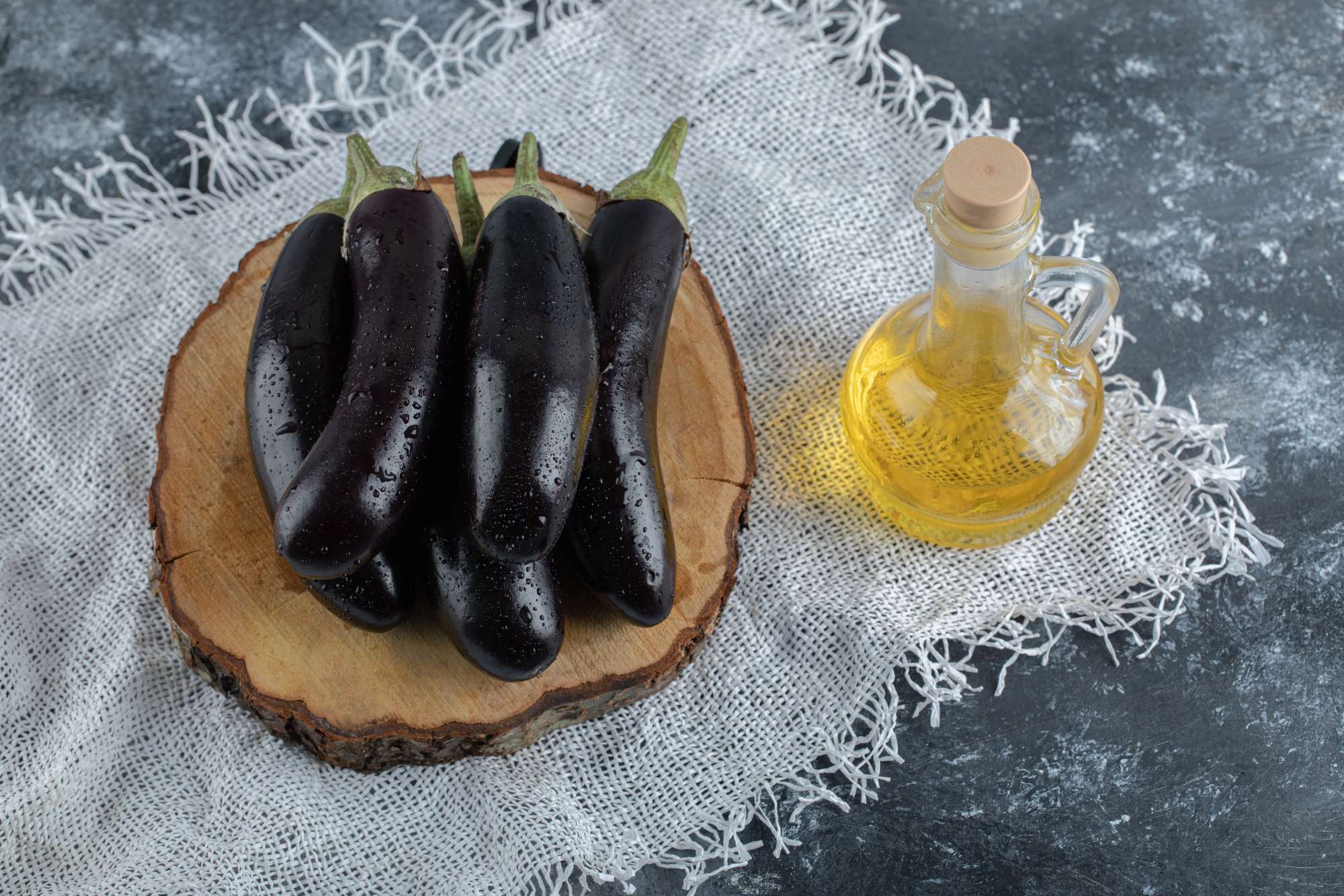 fresh-purple-eggplant-wooden-board-bottle-oil-top-view.jpg