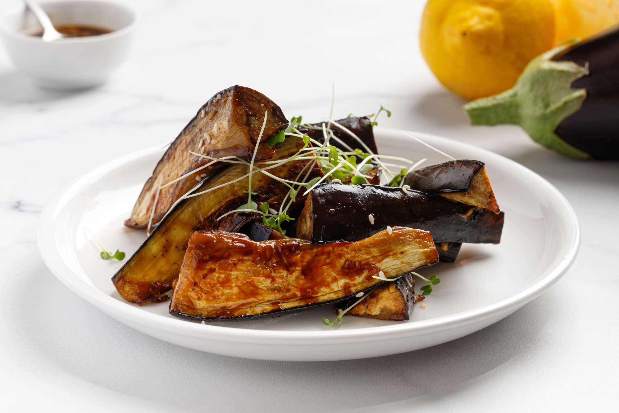 grilled-eggplant-glazed-with-sauce-honey-white-plate-marble-background-delicious-vegan-dish.jpg