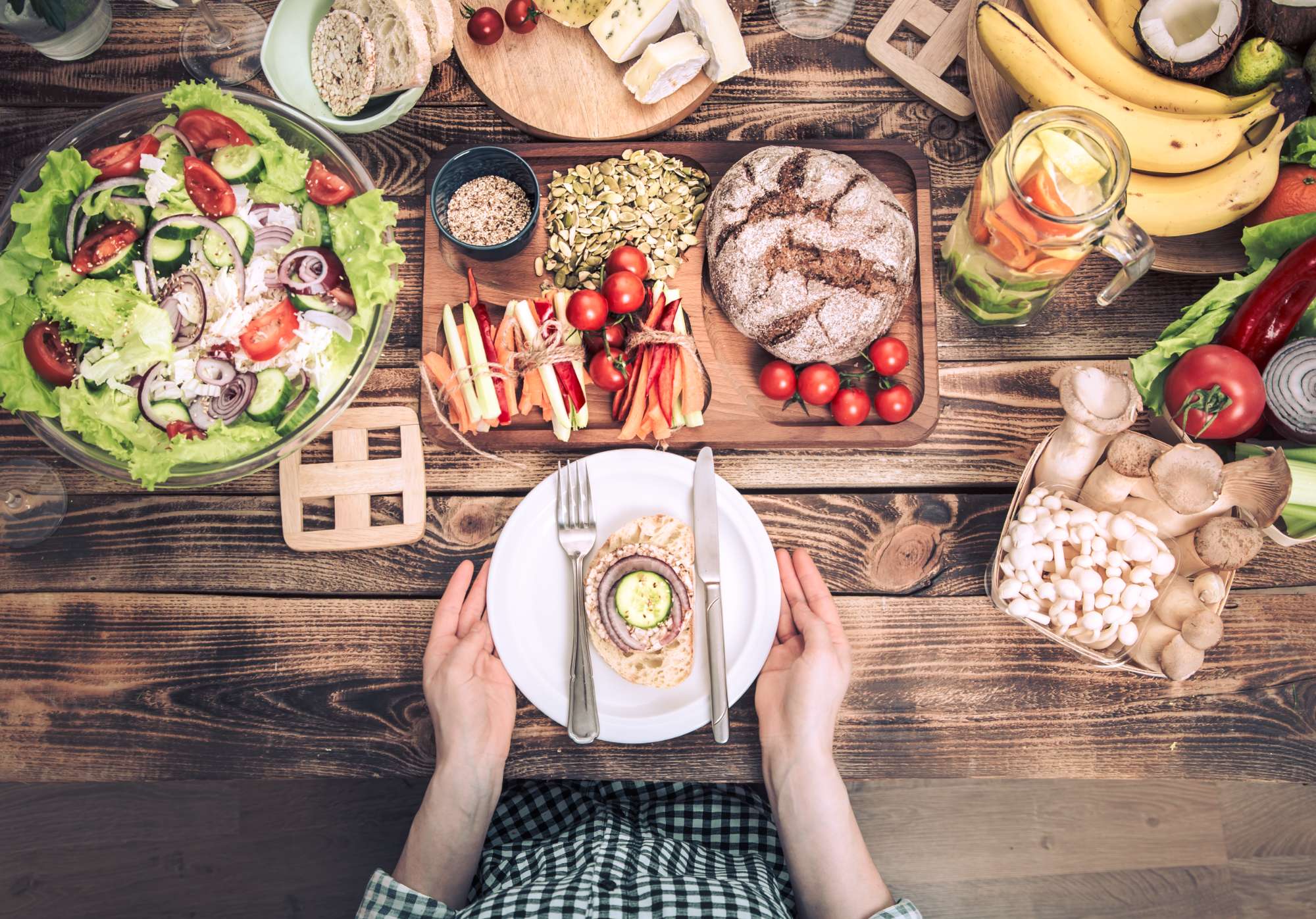 lunch-table-with-different-food-women-s-hands-with-plate.jpg