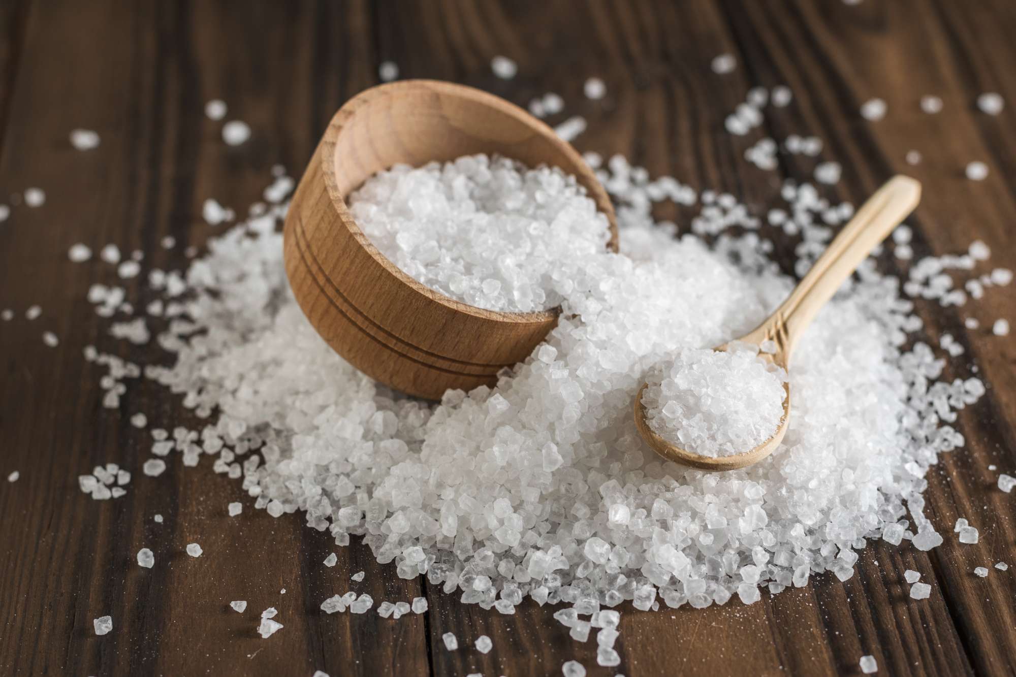 wooden-cup-spoon-with-coarse-salt-crumbling-wooden-table-ground-stone-sea-salt.jpg